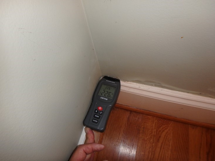moisture meter reading moisture at the corner of a wall